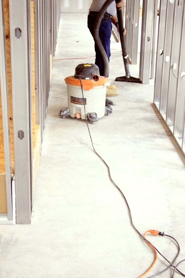 Man Vacuuming a Construction Site